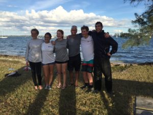 Coach Andrew with a group of high school sailors